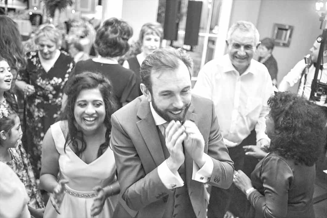 Bride and groom celebrate with family in the Eccles Hotel during their wedding day