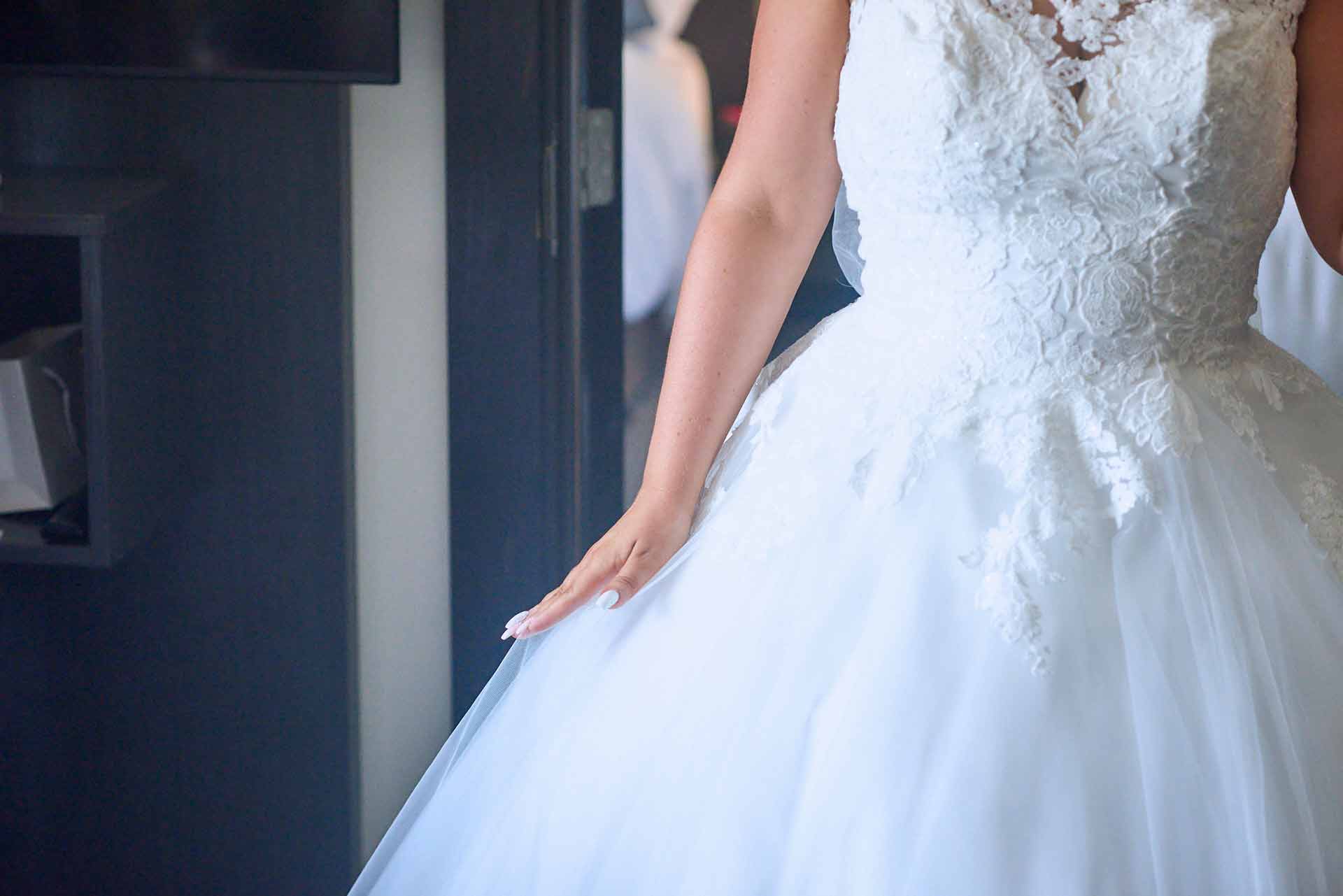 Talbot Hotel wedding photography Bride extends her newly painted fingernails against her large puffy flowing white Cinderella style wedding dress
