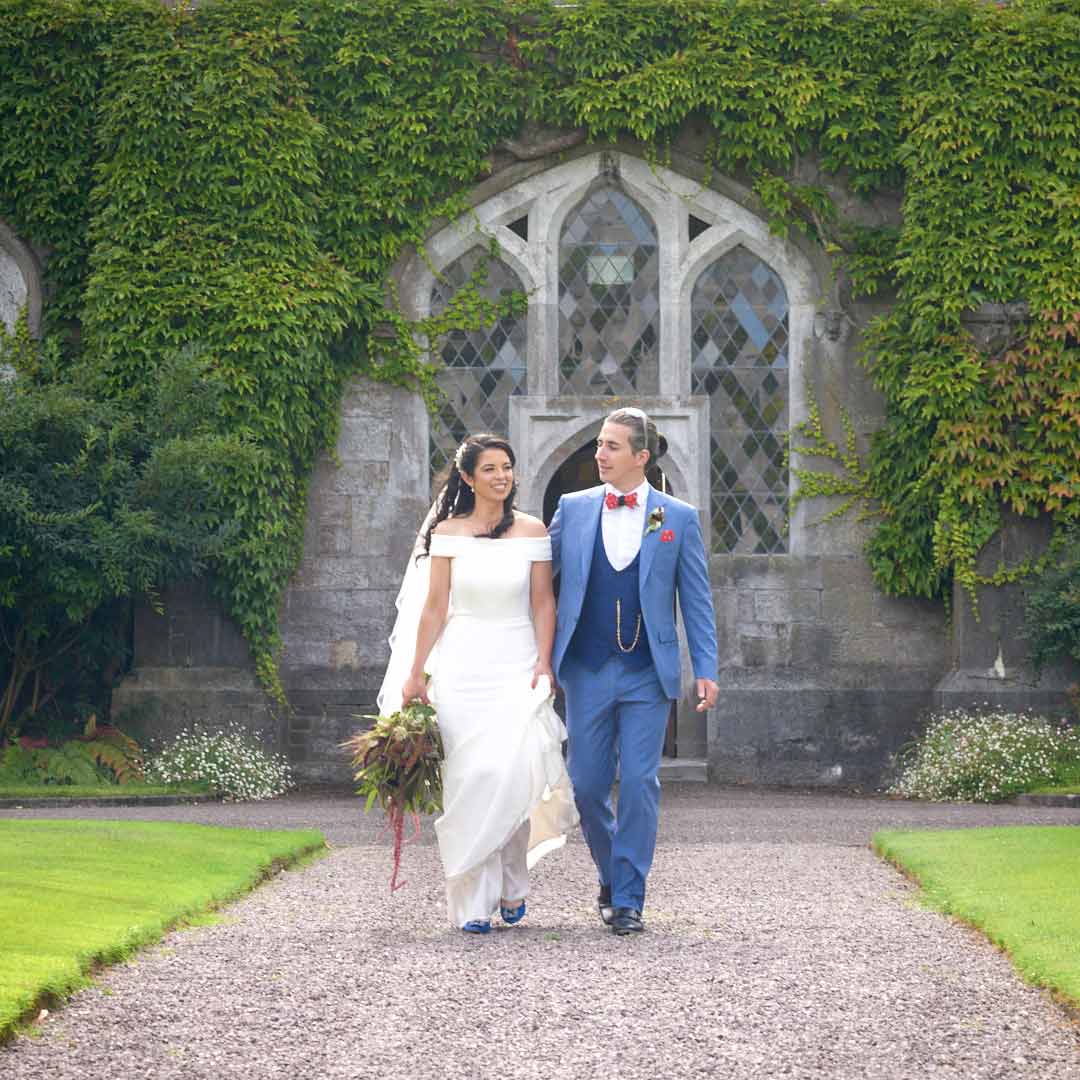 UCC Cork Wedding Photography Back of the grooms blue jacket as he dances with the bride during the first dance. We can see the left hand of the bride wrap around his waist with bright red nail polish and her wedding ring.